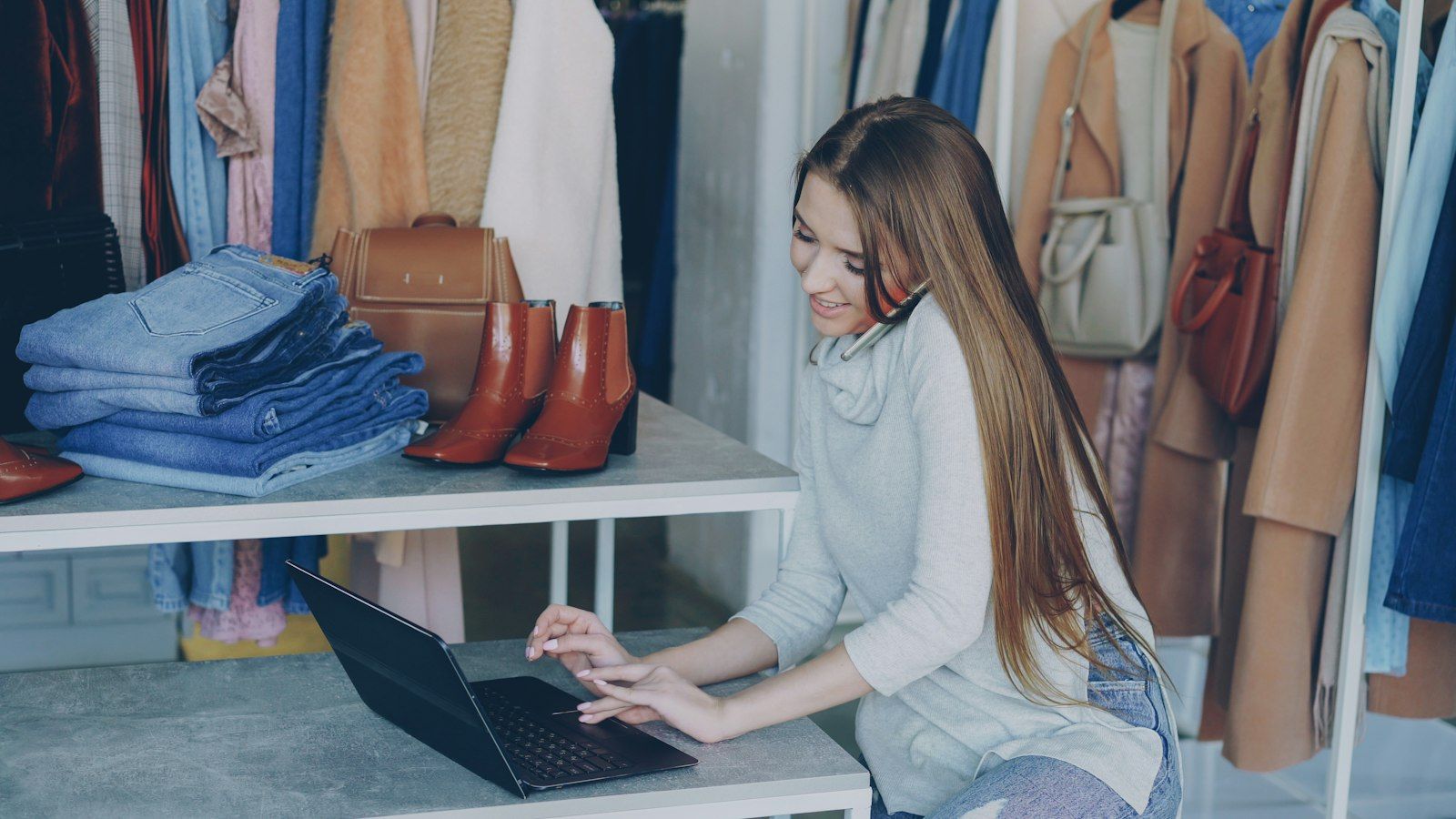 Boutique owner at a laptop