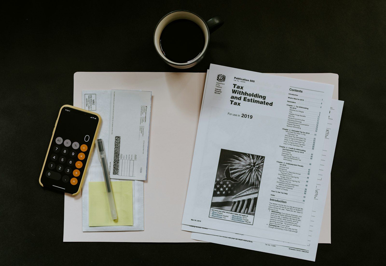 Tax forms and a calculator on a desk