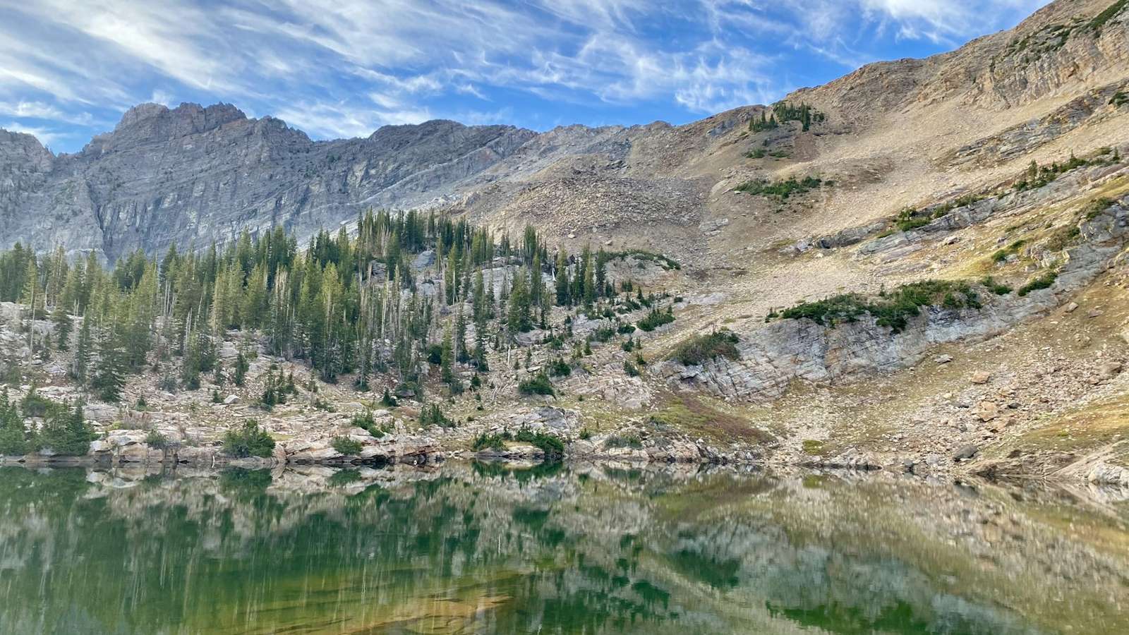 Alpine lake below rocky ridges
