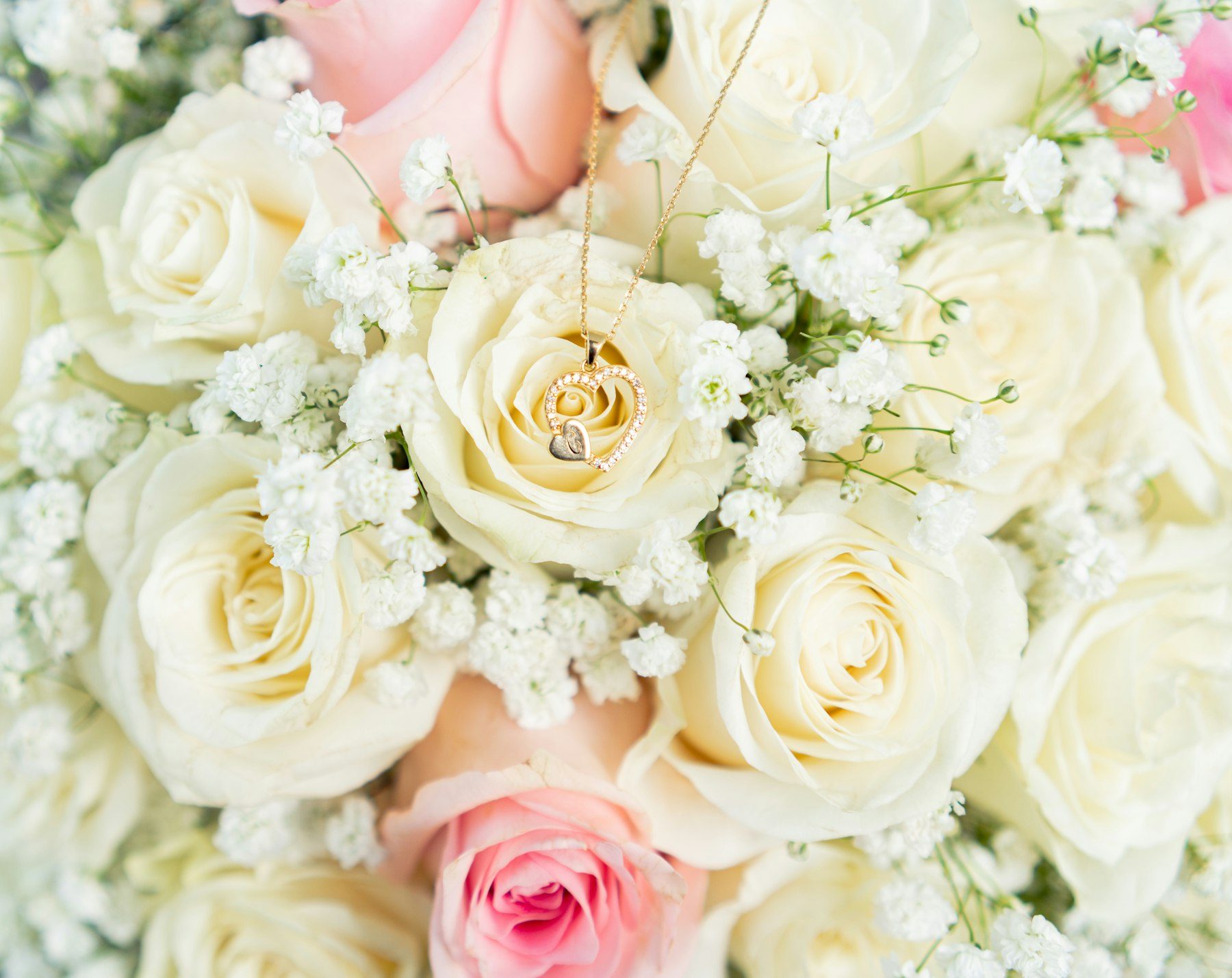 A bouquet of white and pink roses and baby's breath