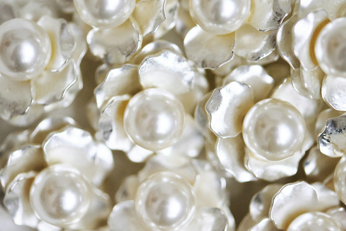 White flowers with pearl centers fill the frame