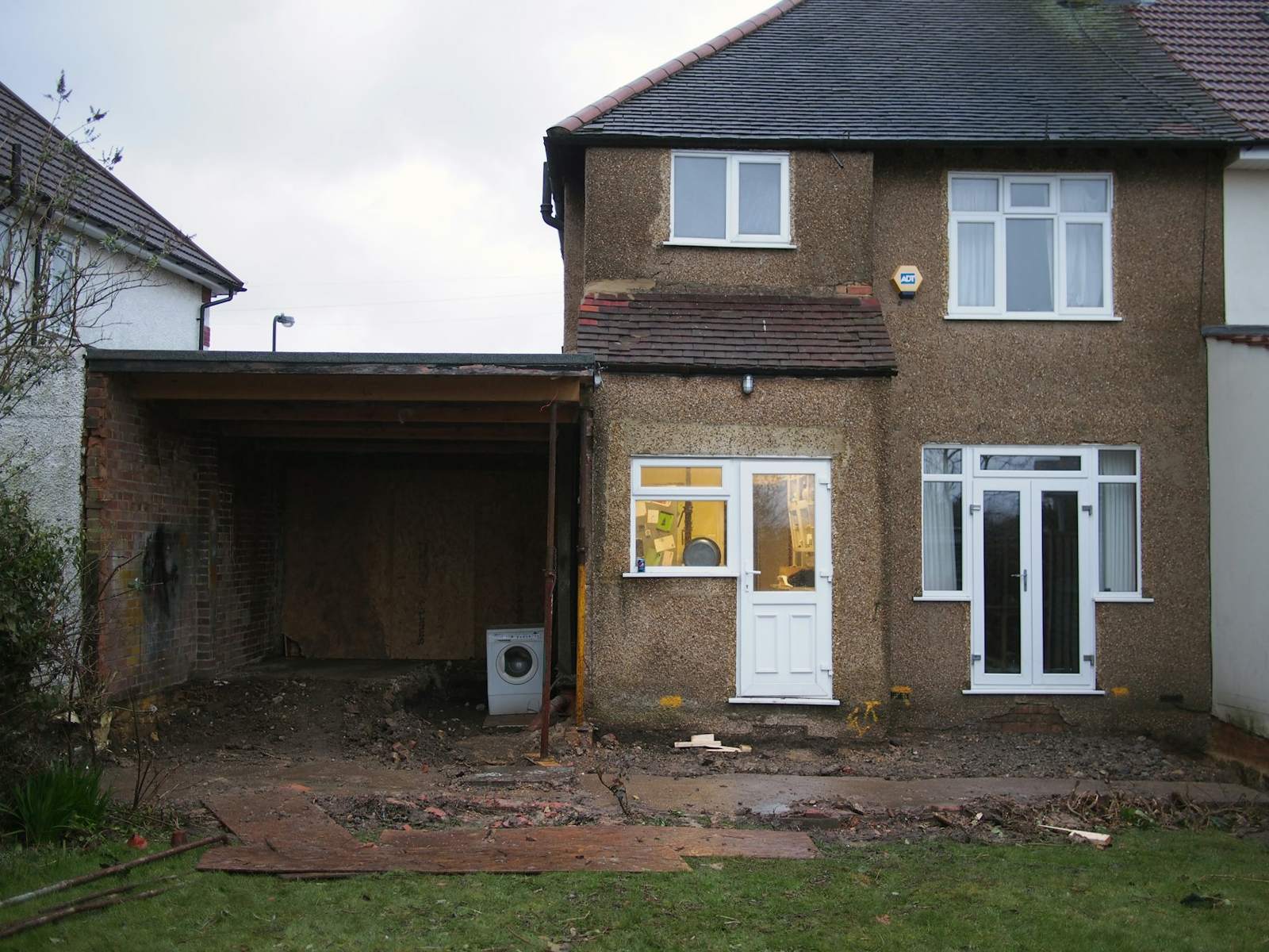 Before: brick house with an old lean-to at the back