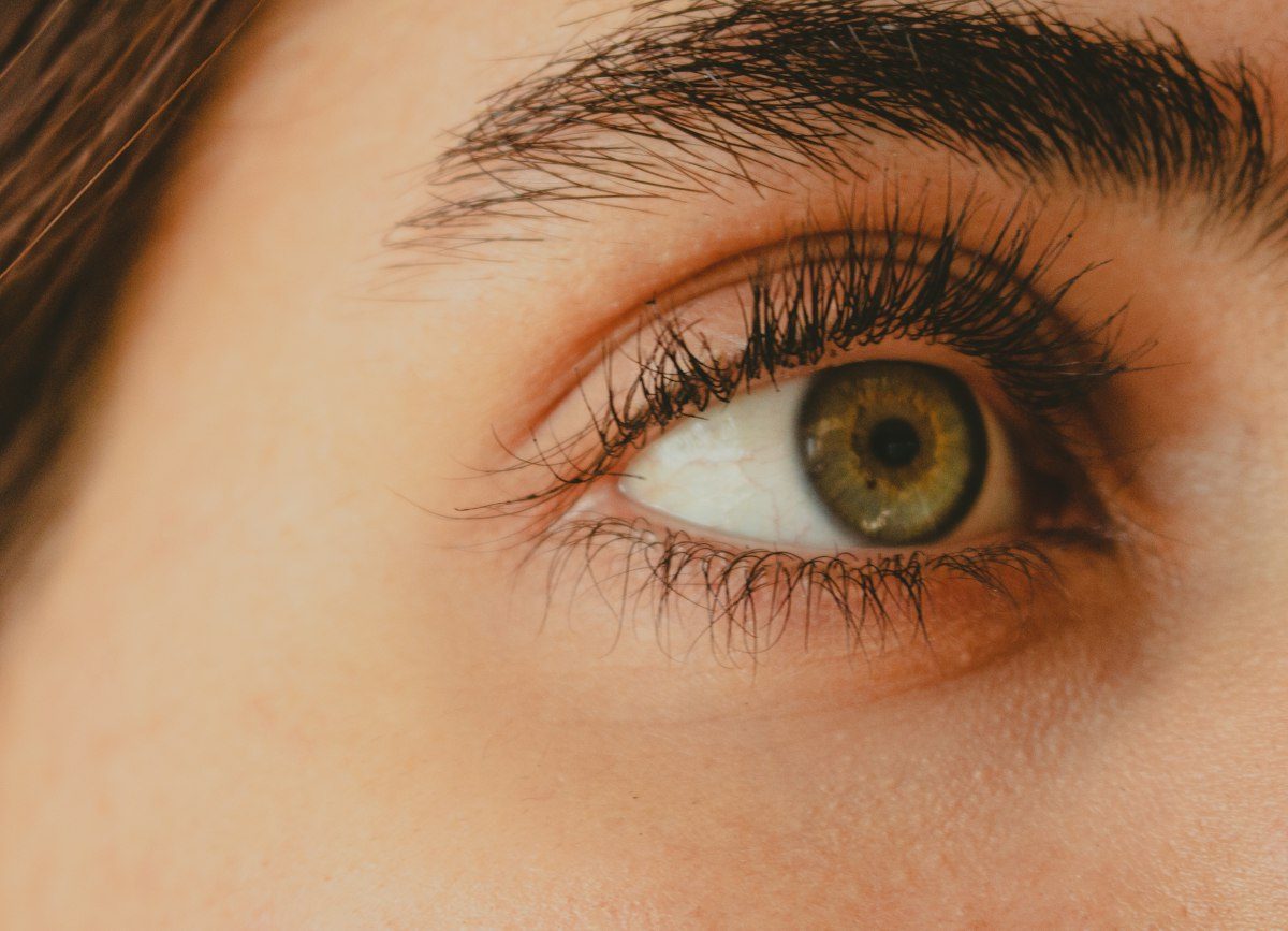 A close up of a person's eye with long lashes