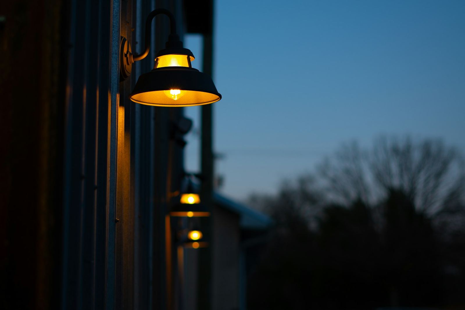 Warm exterior wall lights at dusk