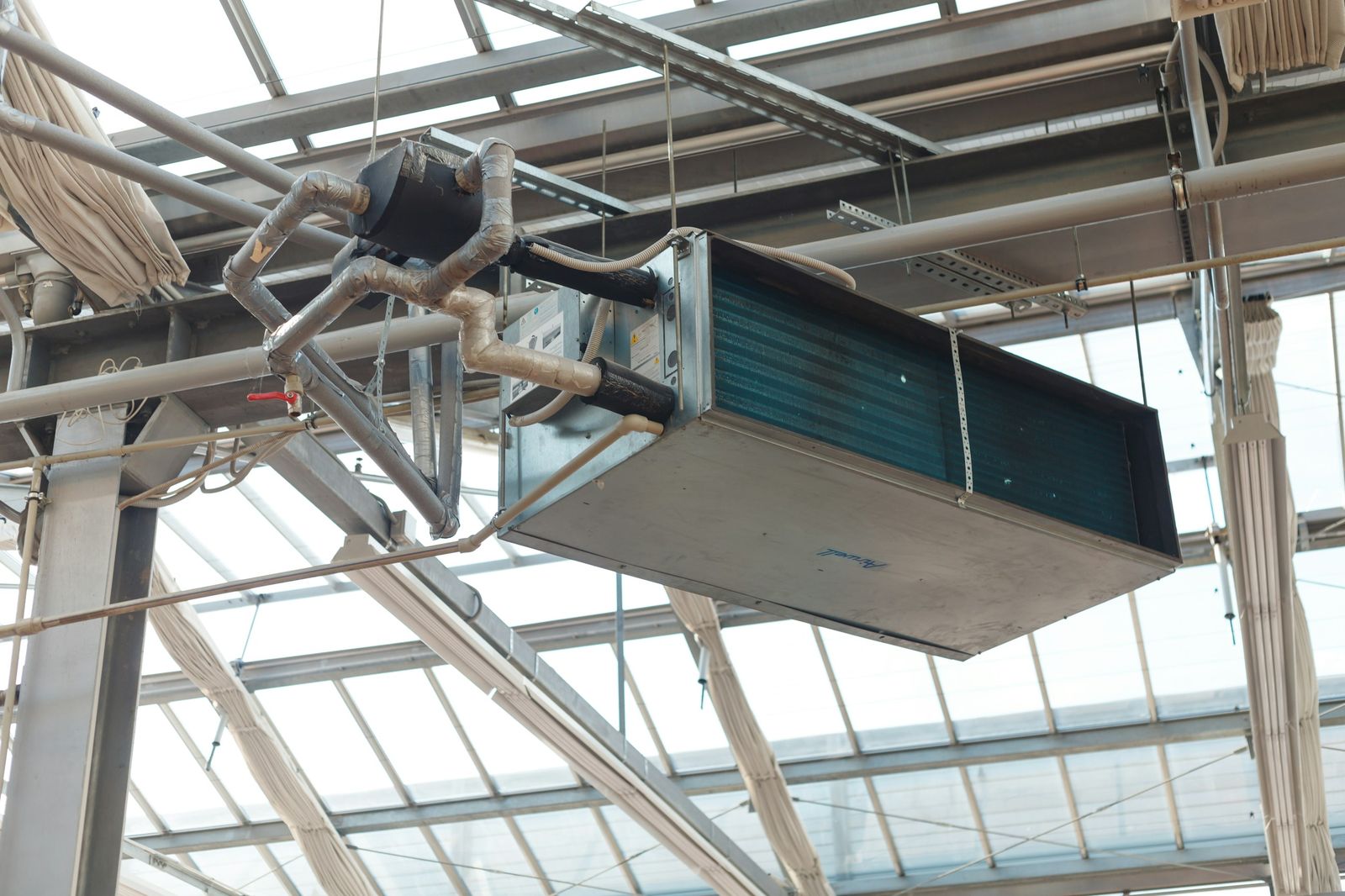 Suspended air handling unit under a glass roof