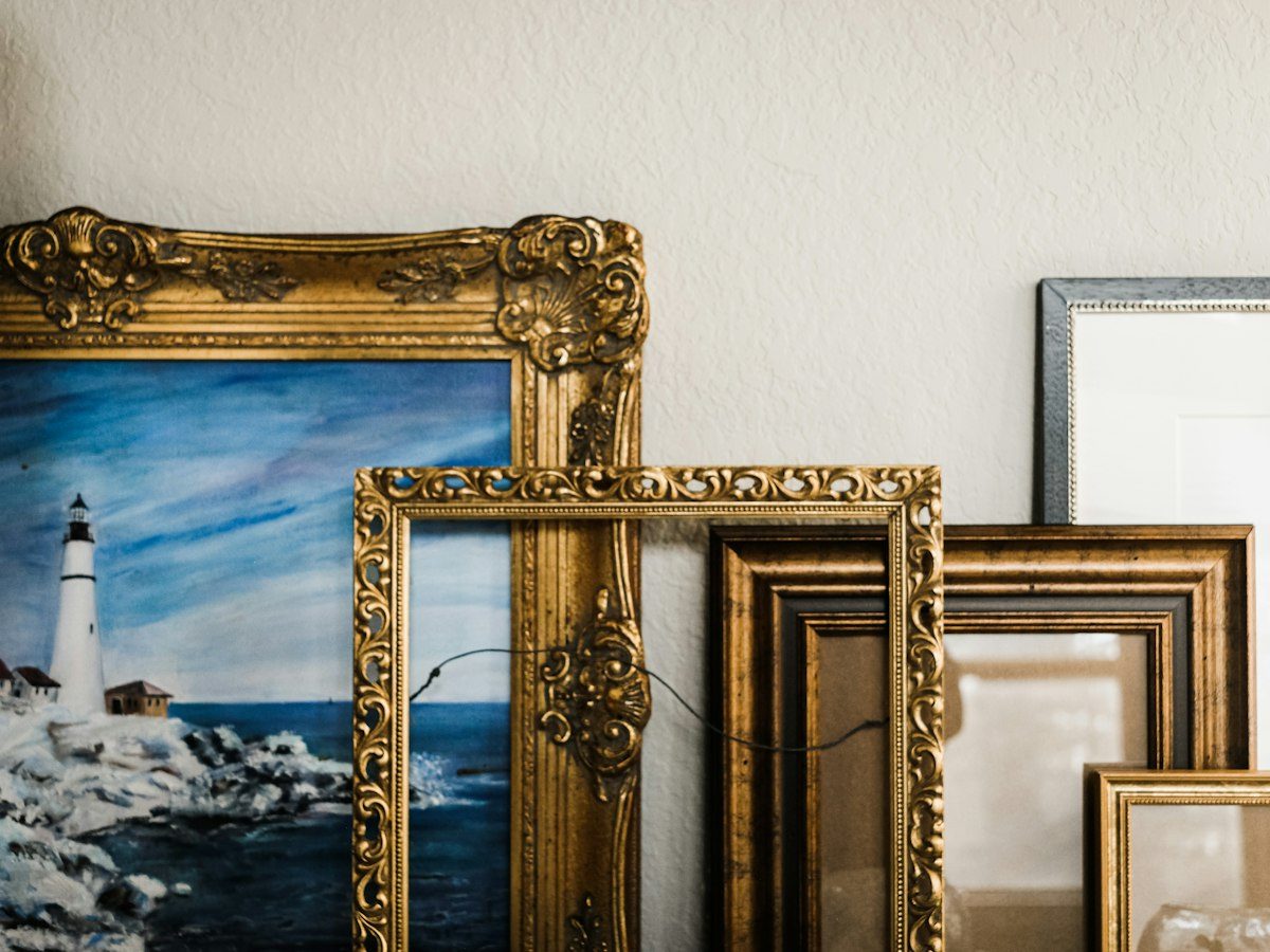 Gold framed mirror on white wall