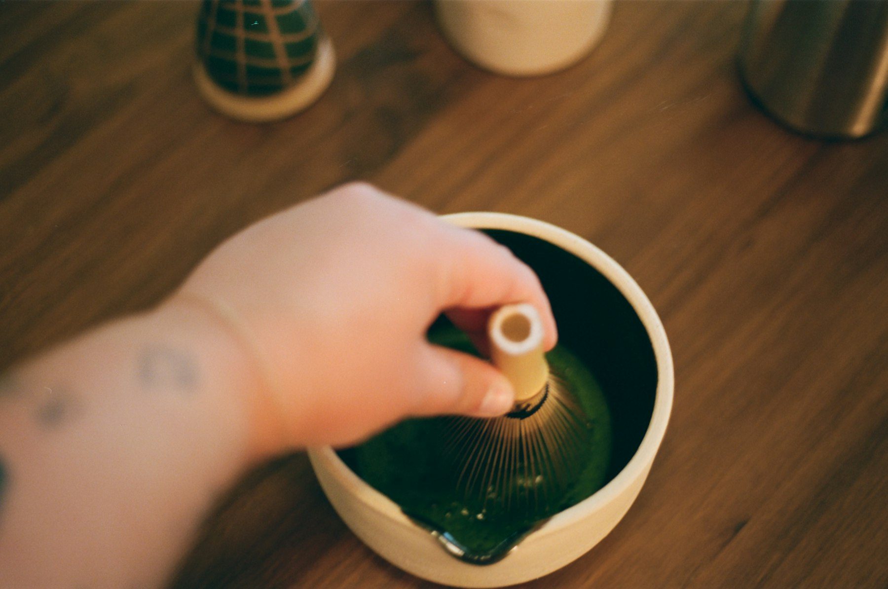 Preparing matcha tea with a whisk
