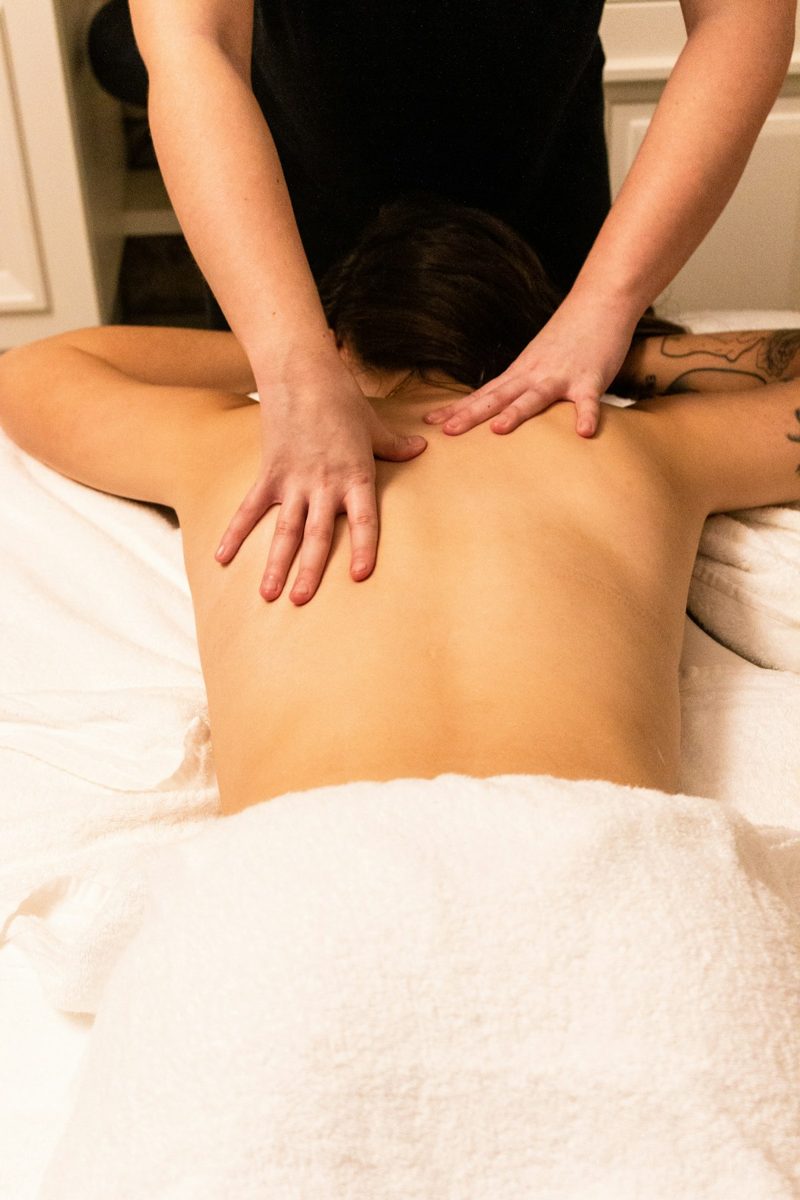 A woman getting a back massage at a spa