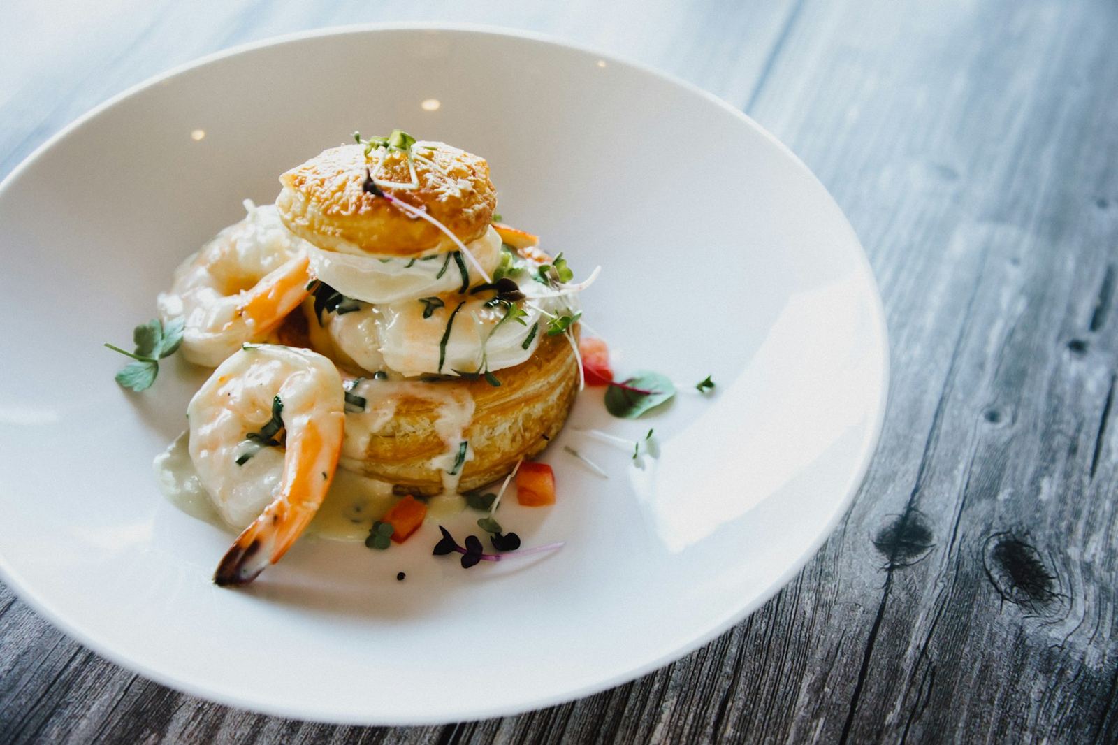 Scallops and shrimp over a potato cake
