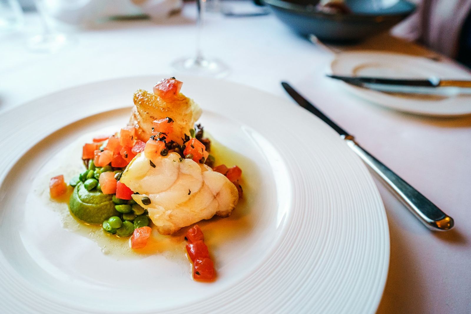 Lobster tail over a bright tomato and herb salad