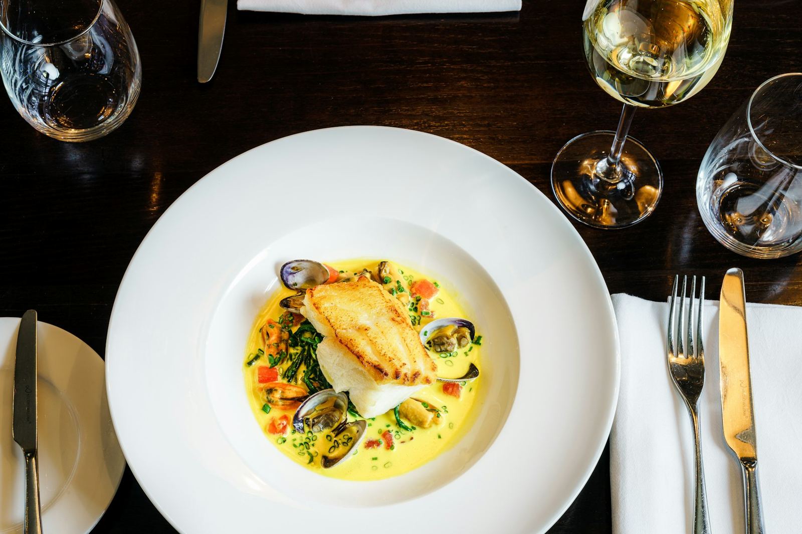 Seared fish in a saffron broth with mussels