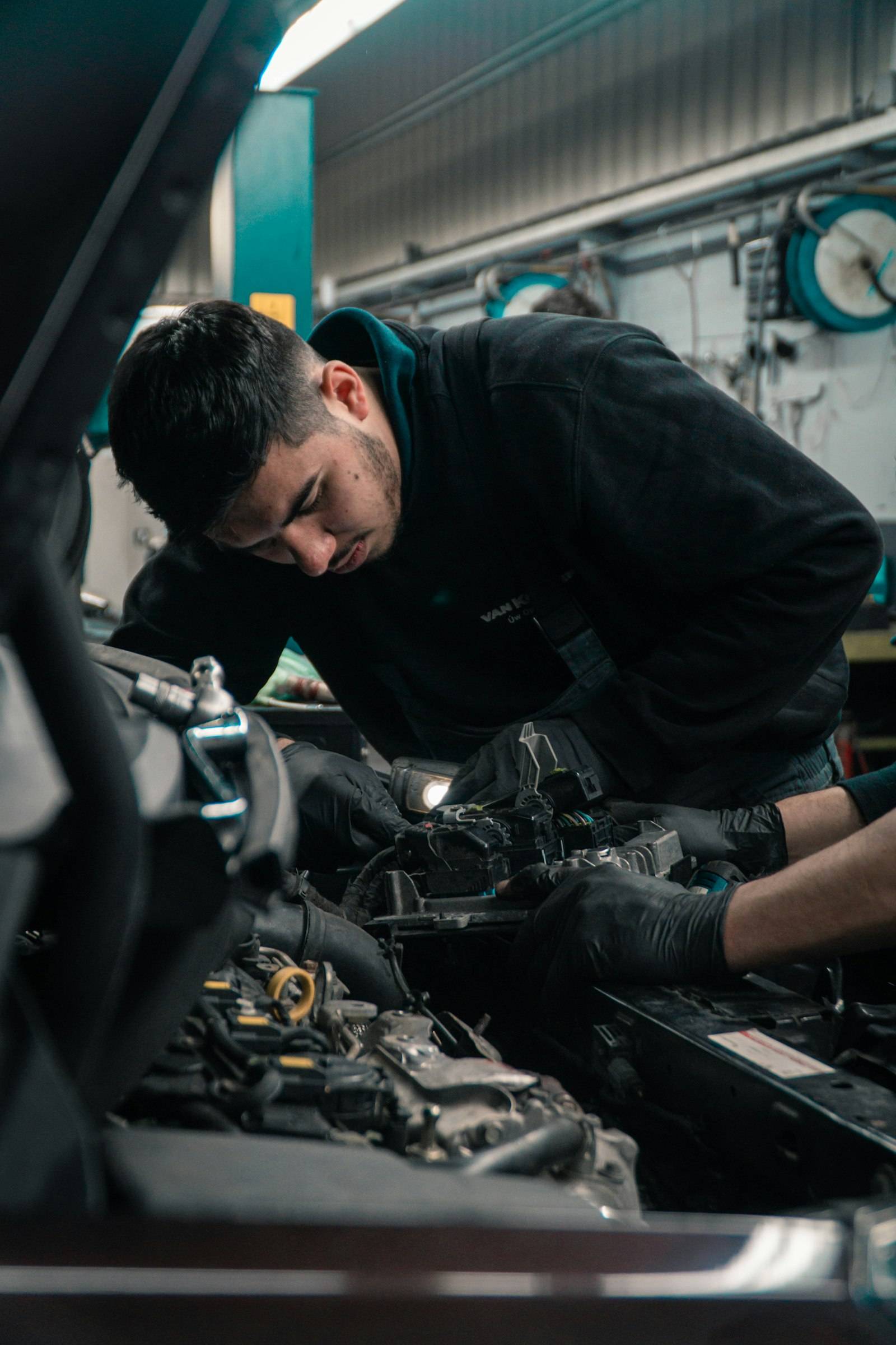Mechanic leaning into an engine bay