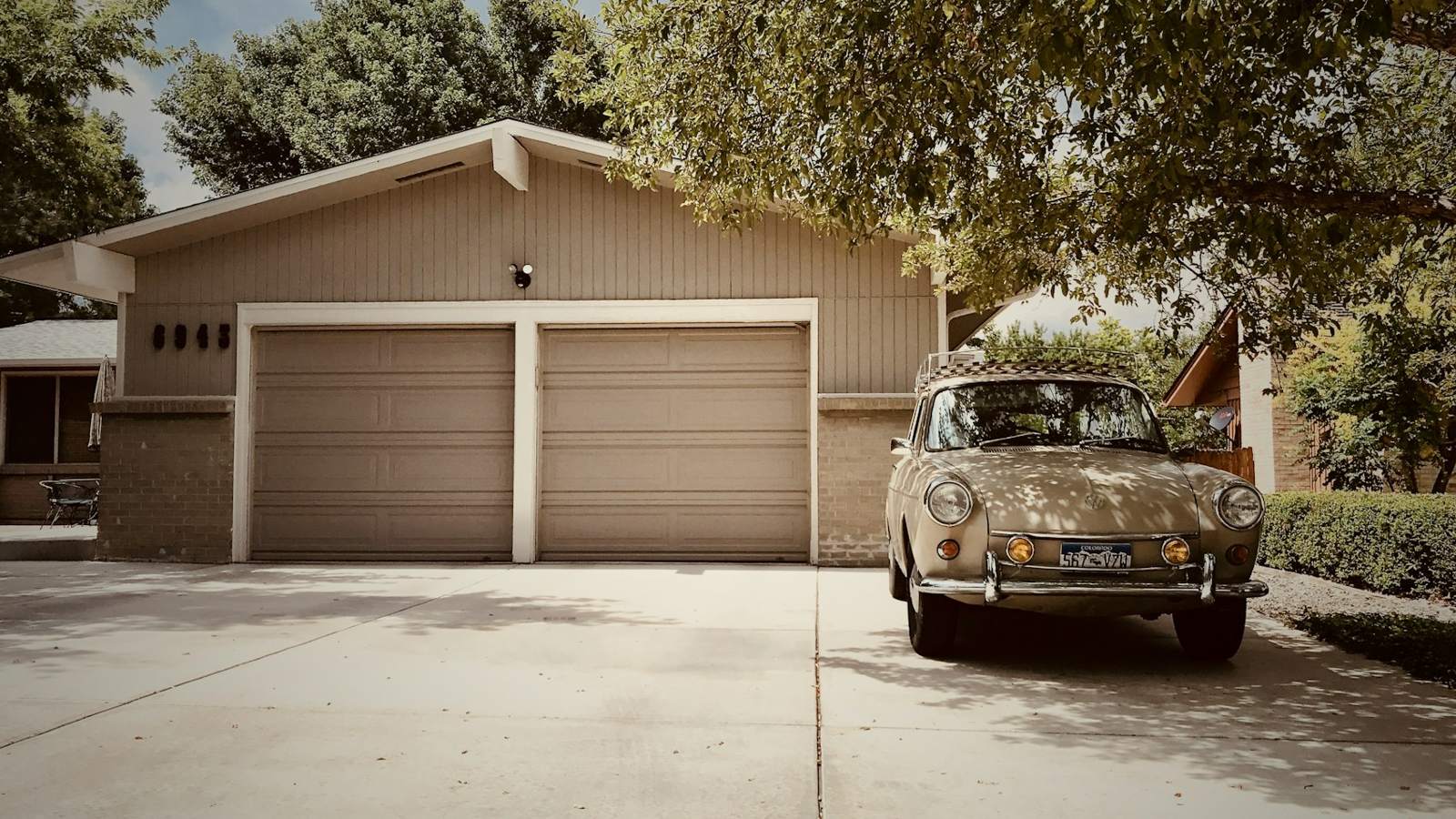 Garage with vintage car in front