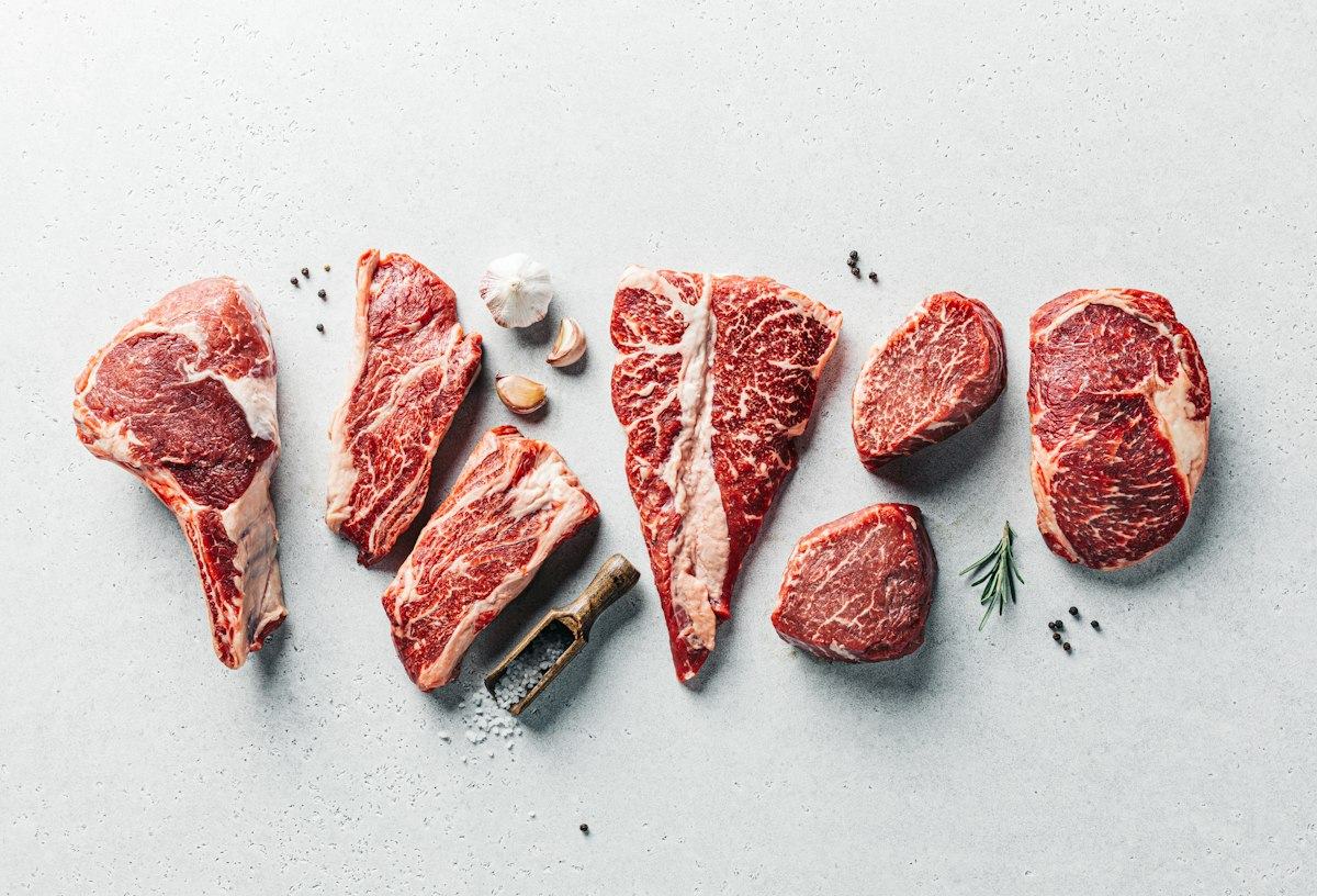 A group of raw meats on a table