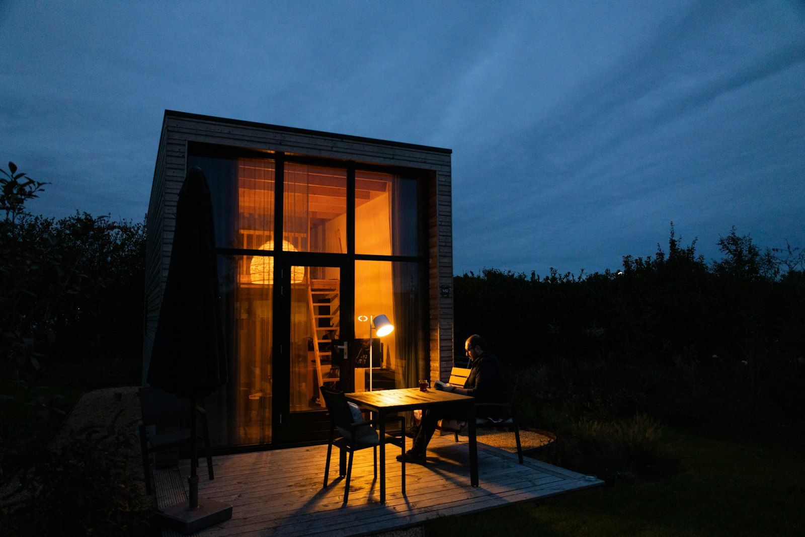Small modern home glowing at dusk