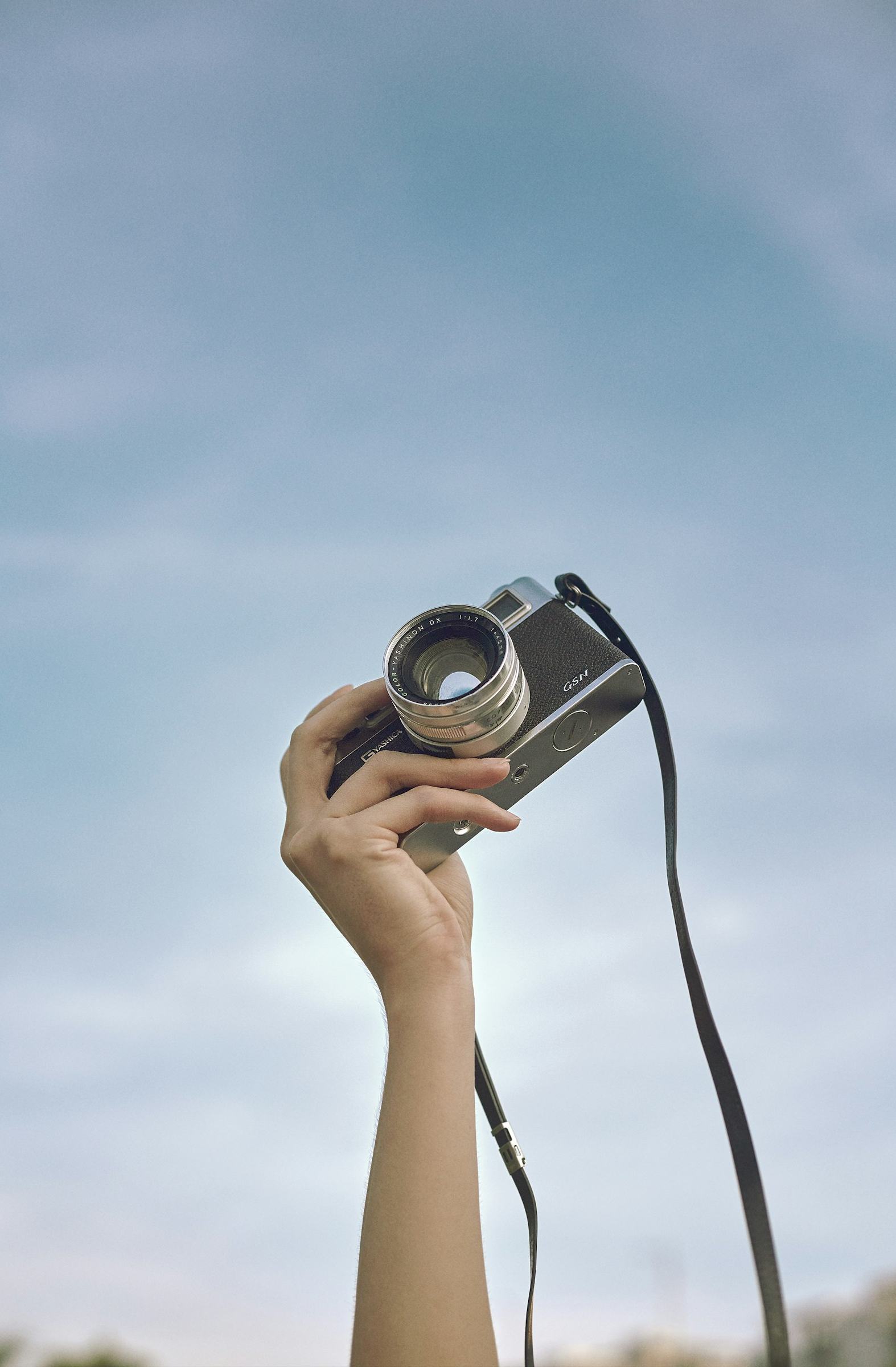 Twin-lens reflex film camera on a light grey background
