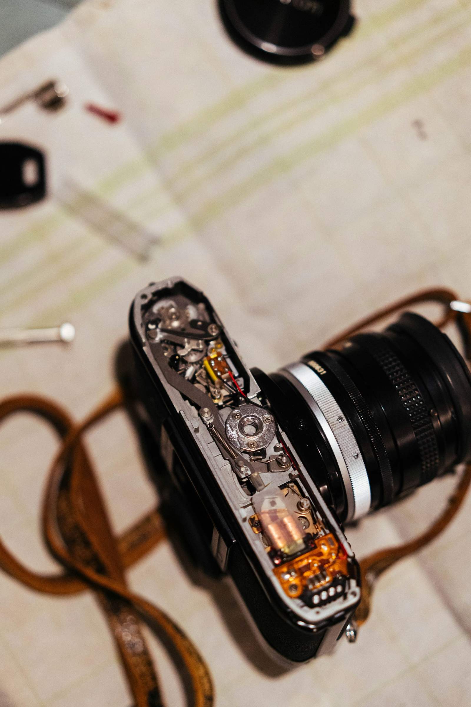 Silver rangefinder camera on a strap