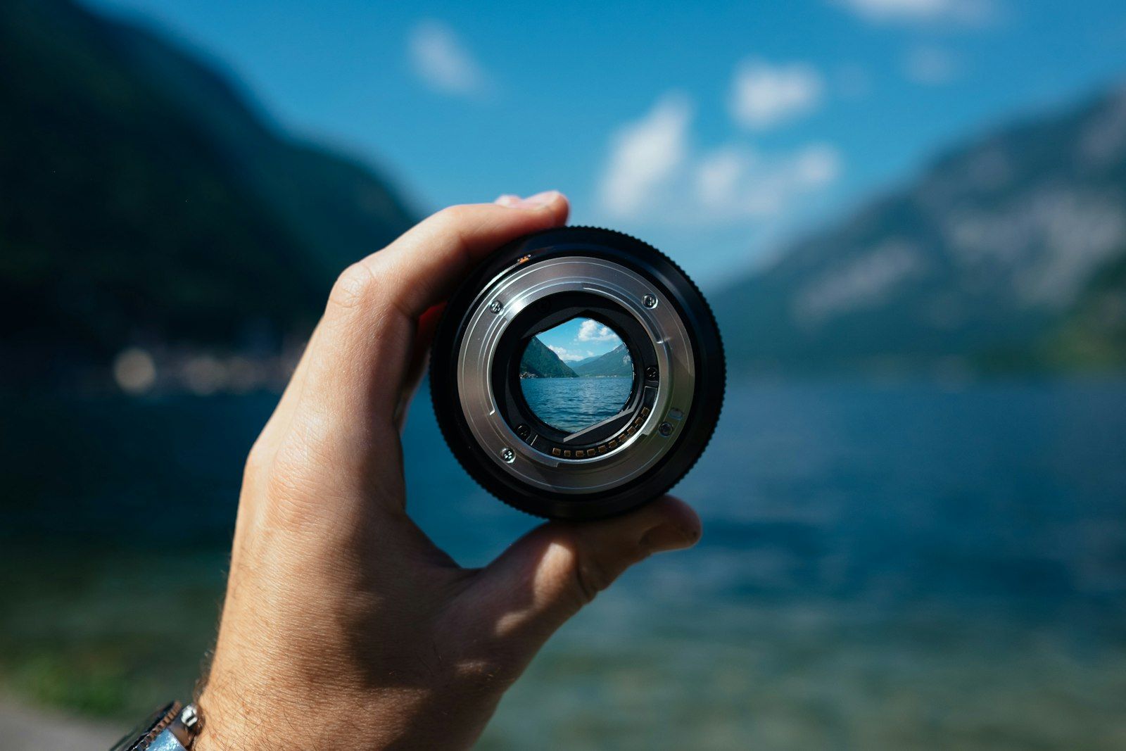 Lens held up against a lake