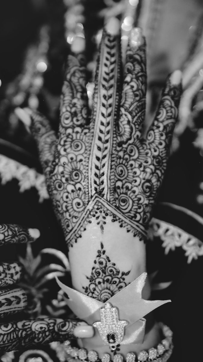 Grayscale photo of person with floral tattoo