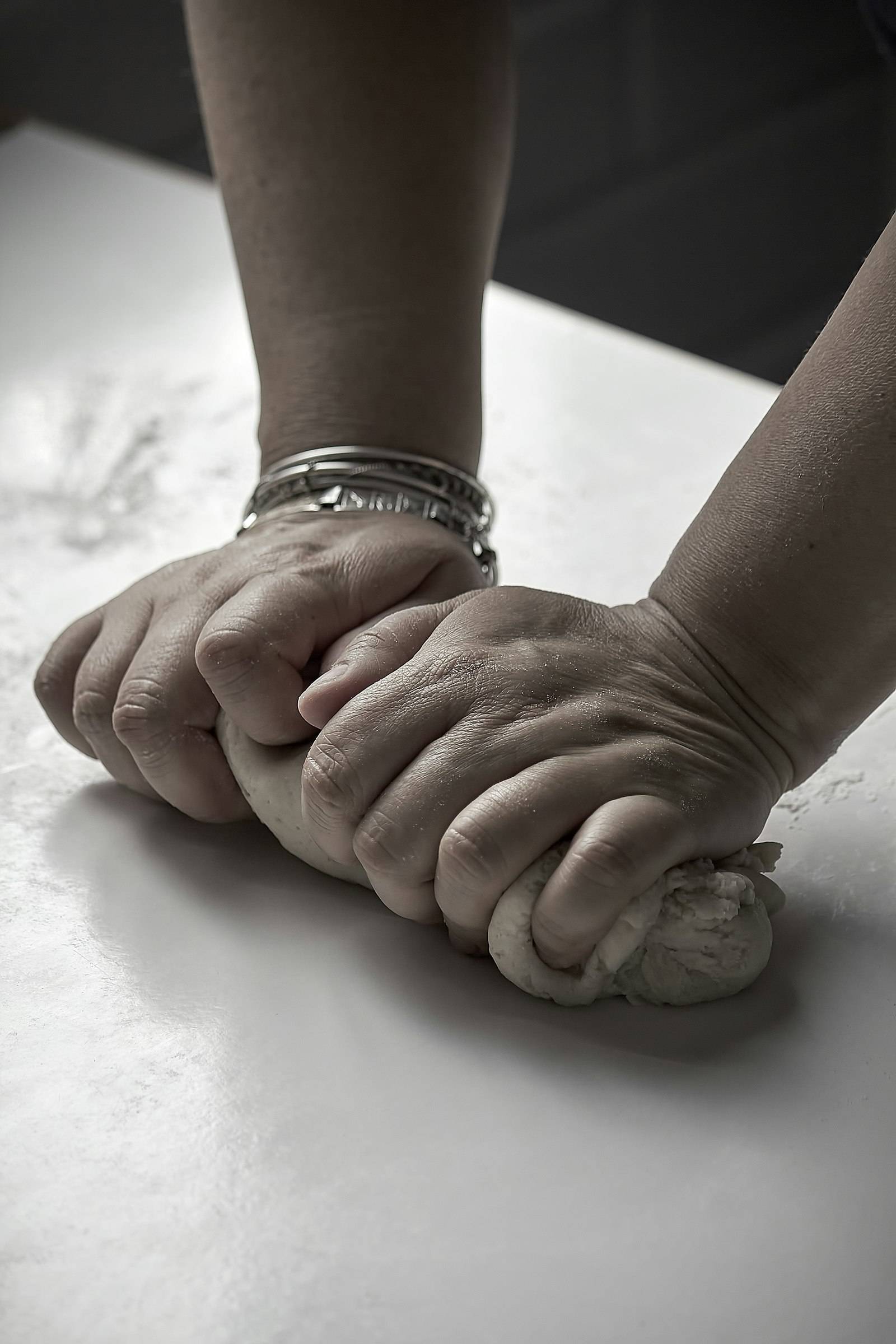 Hands kneading dough