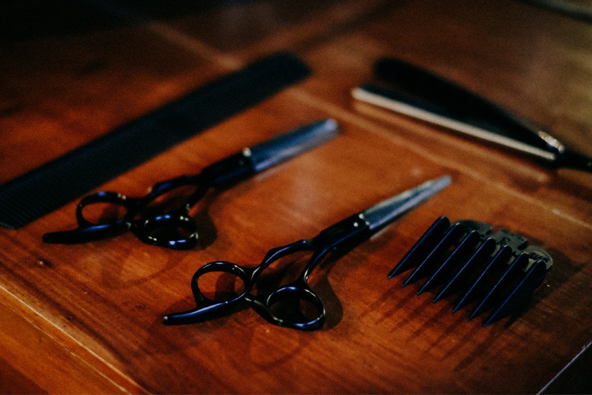 Black framed eyeglasses beside black pen