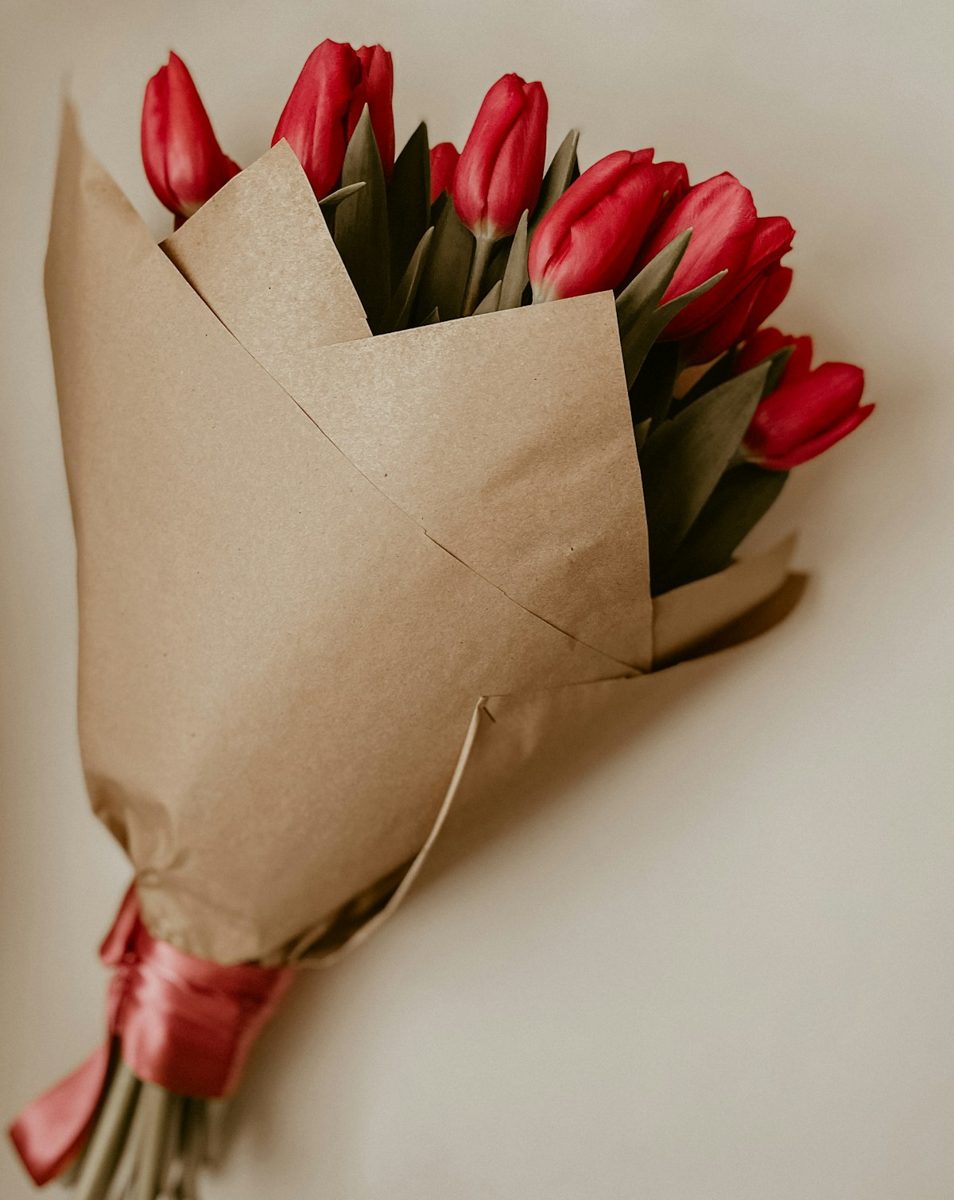 Red and green flower petals on brown paper bag