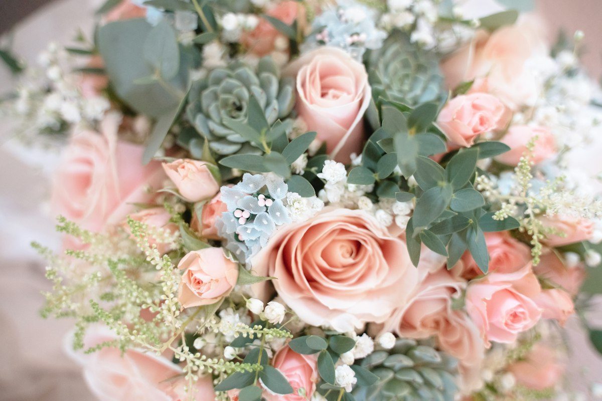 A bridal bouquet of pink roses and succulents