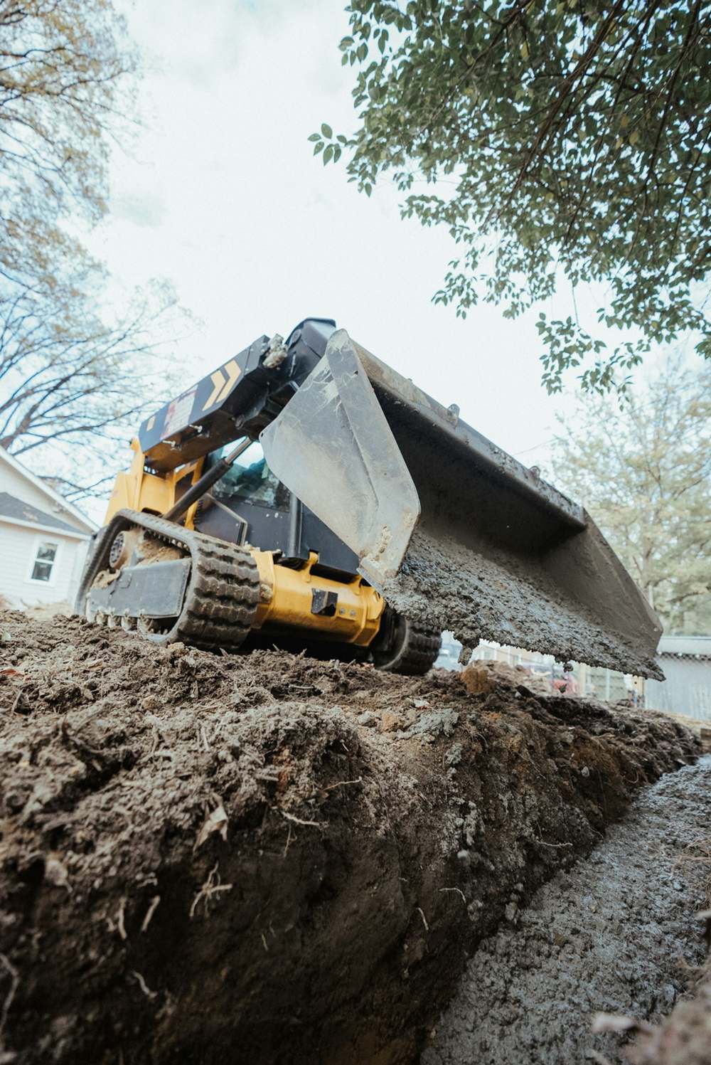 Track loader bucket in dirt