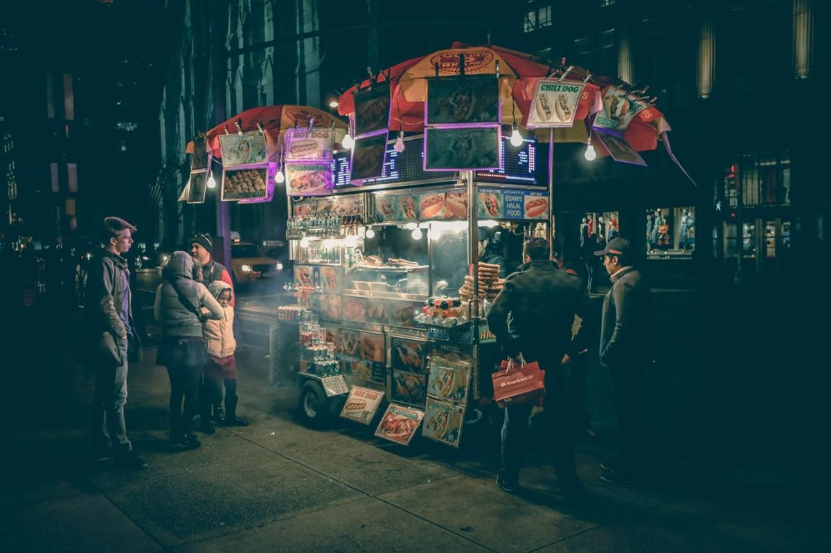 A street-food cart under string lights