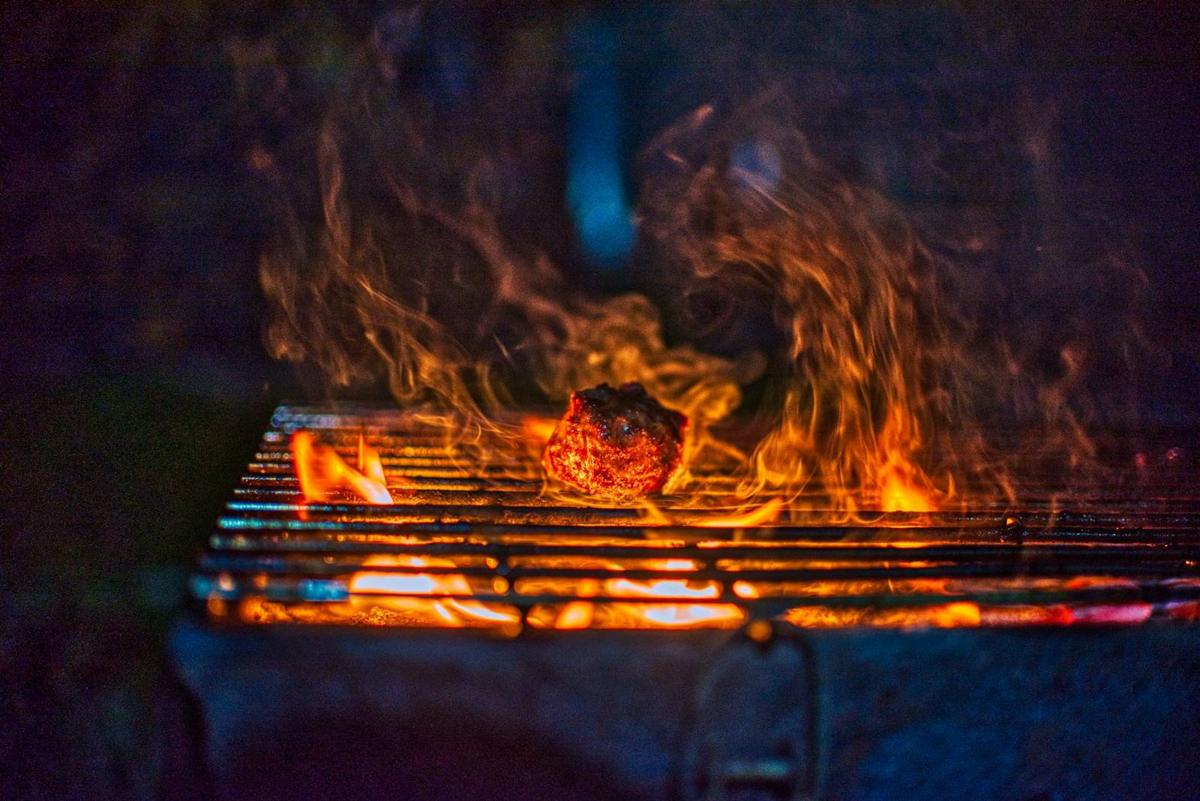 Flames licking a grill