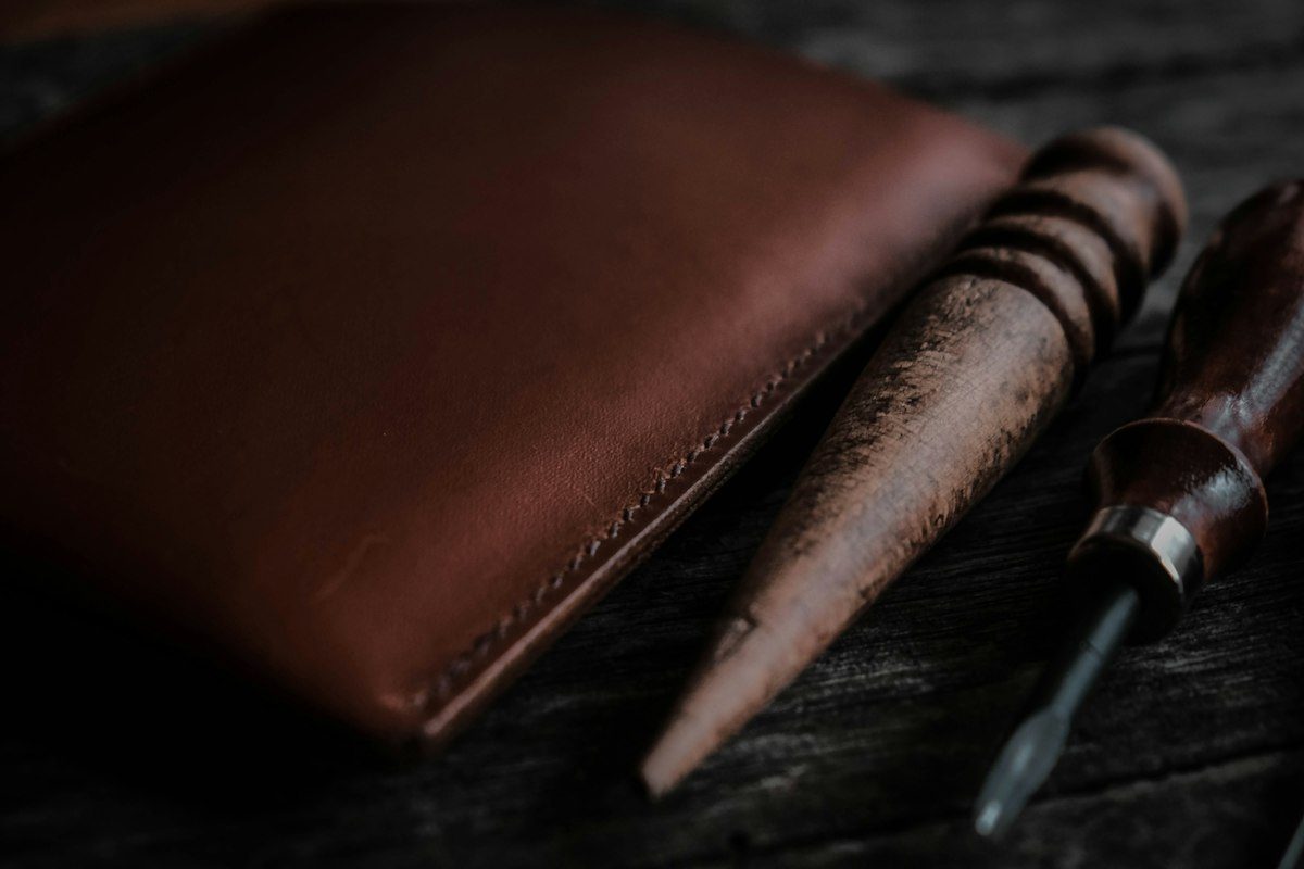 A pen and a wallet sitting on a table