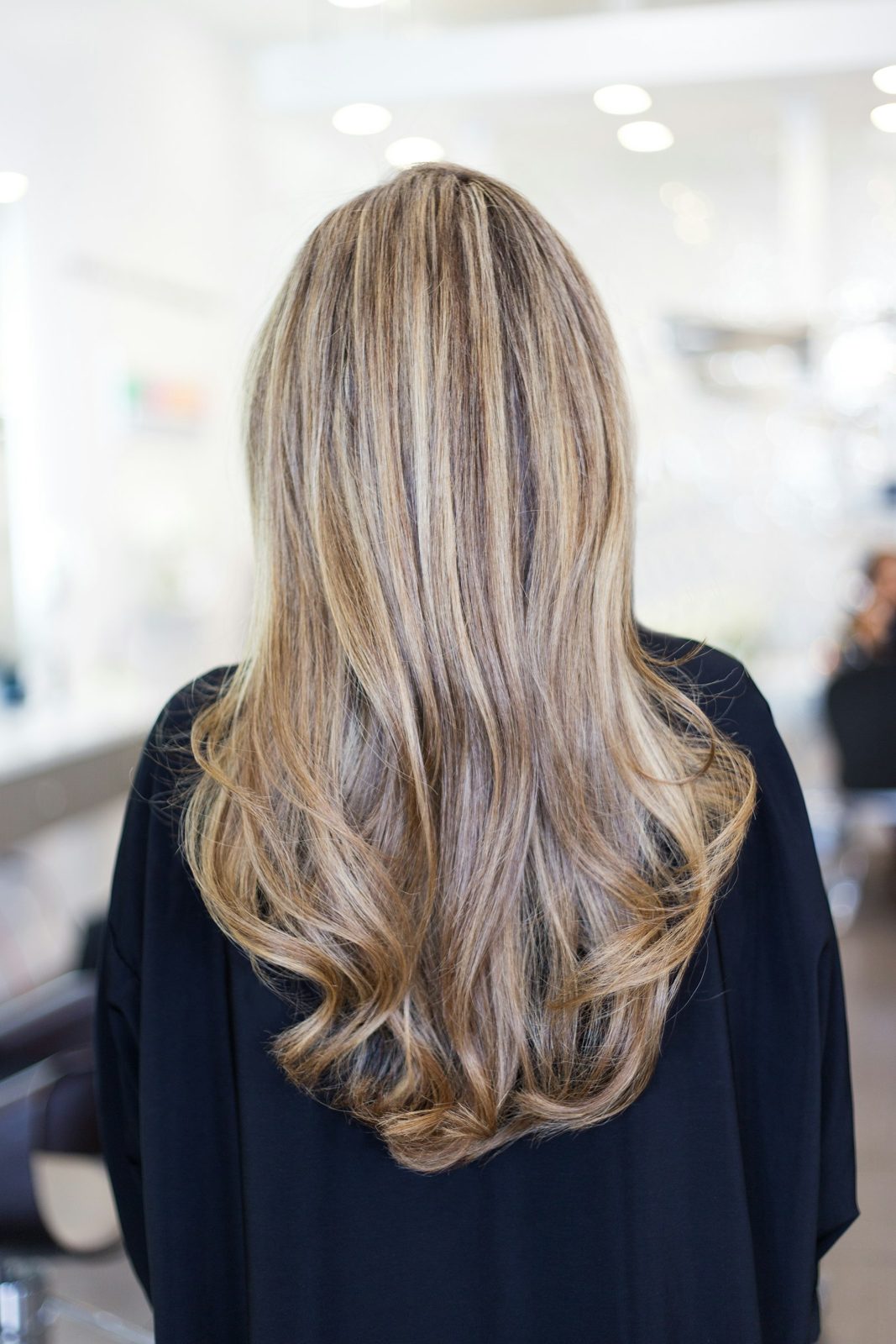 Long, softly layered brunette hair with natural highlights