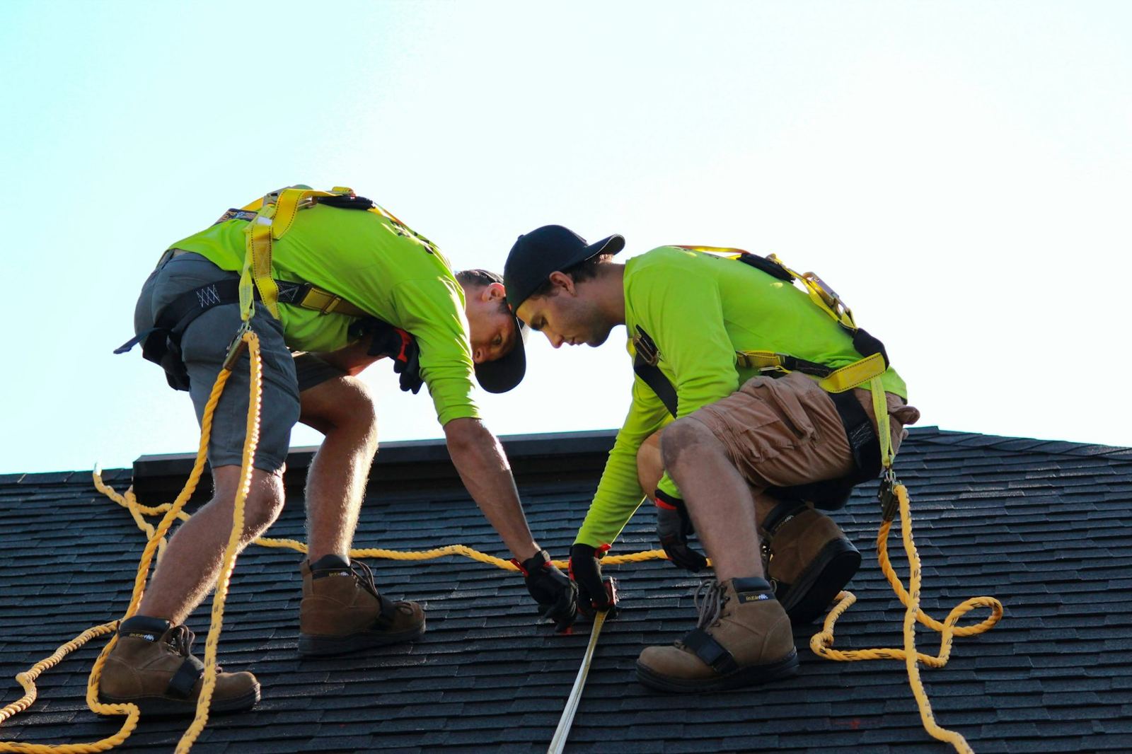 Installers measuring on a roof