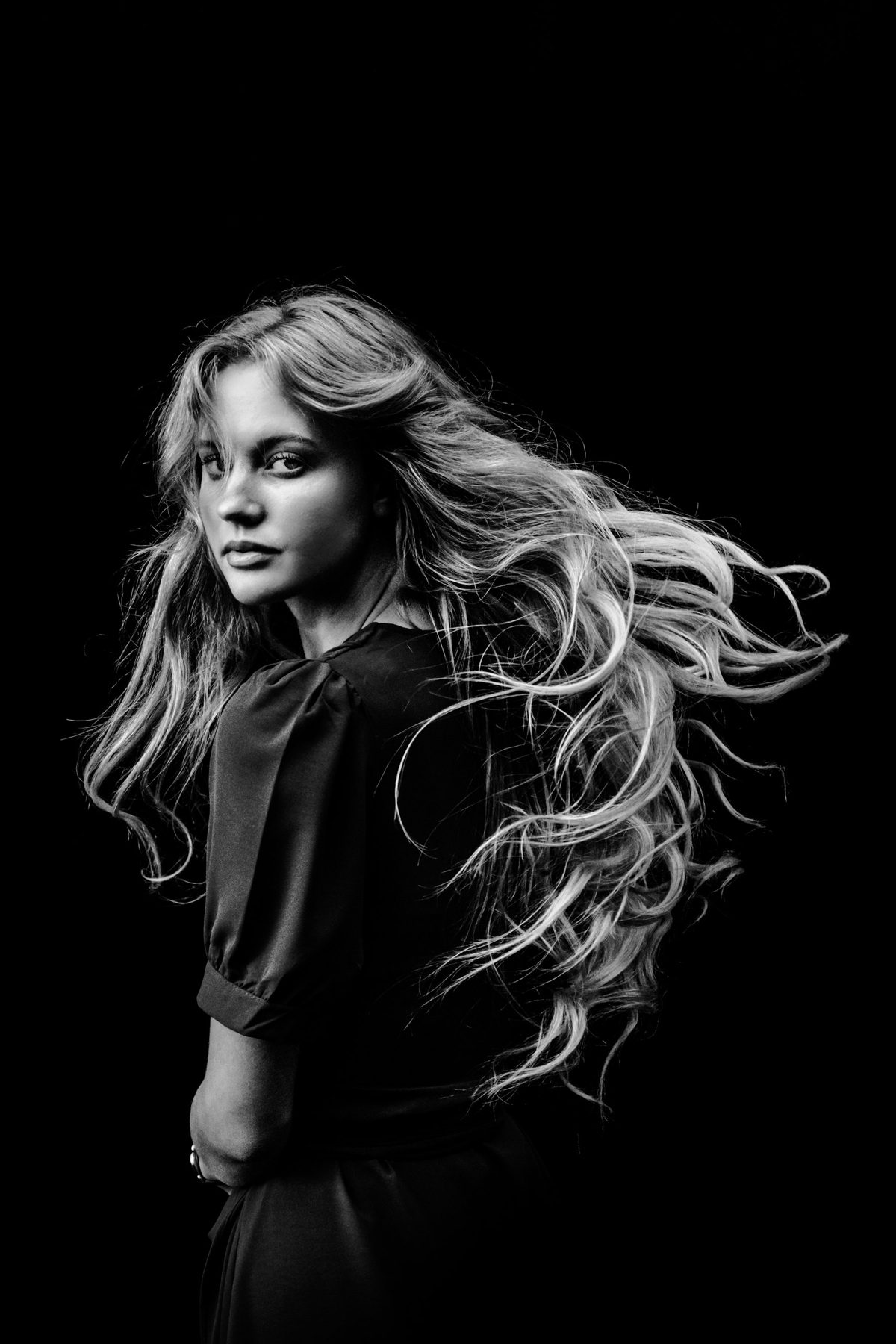 A black and white photo of a woman with long hair
