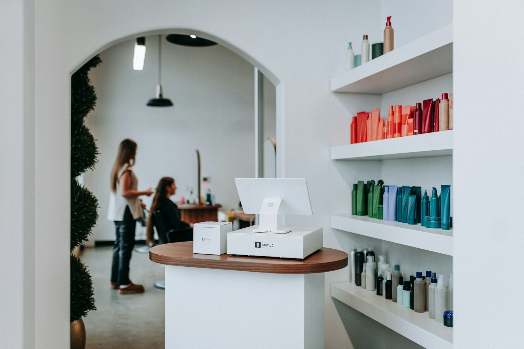 A hair salon interior with hair products and clients