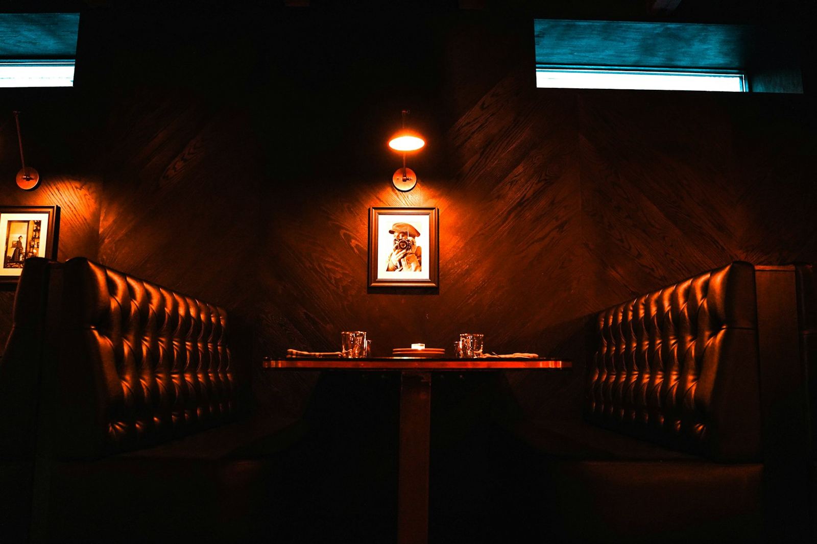 Red velvet booths in a dim lounge