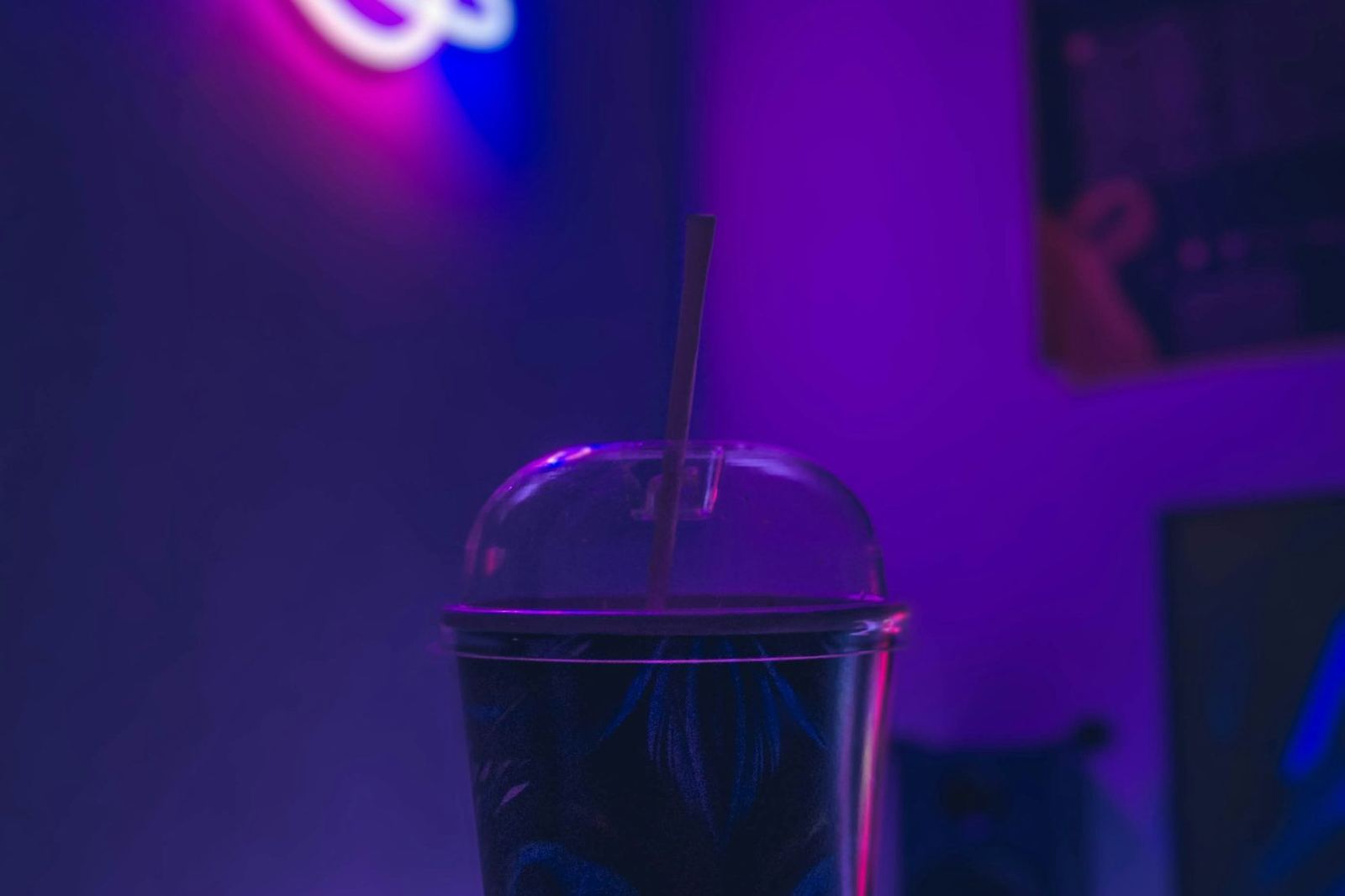 Neon-lit drink on a desk