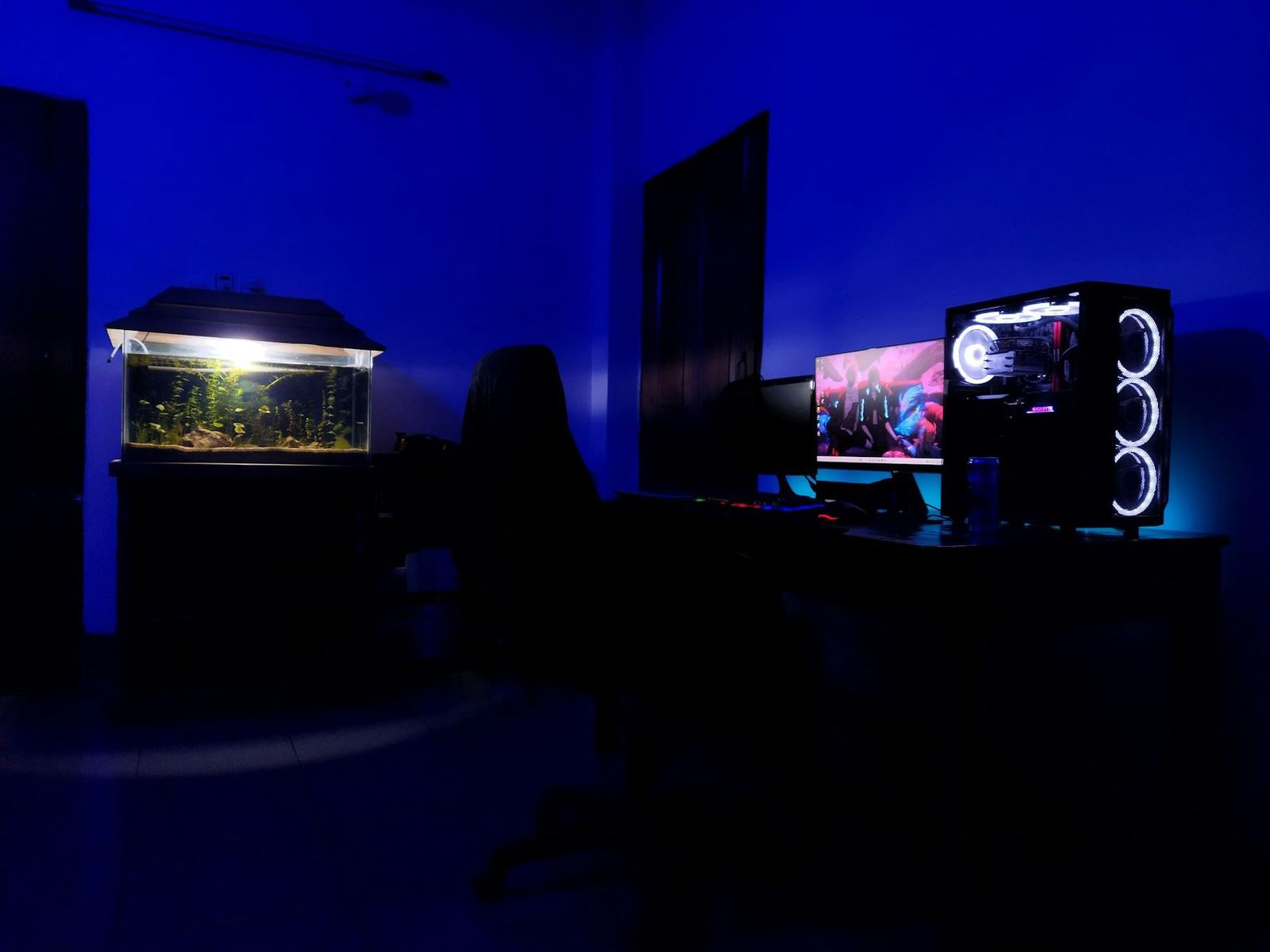 Gaming desk glowing in a dark room
