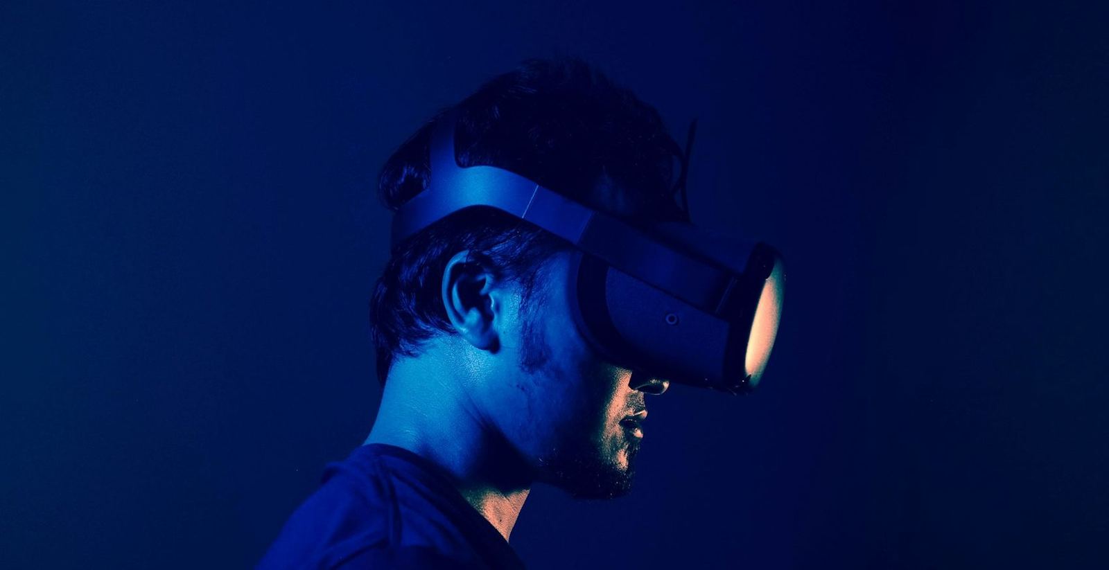 Player in a VR headset lit in blue