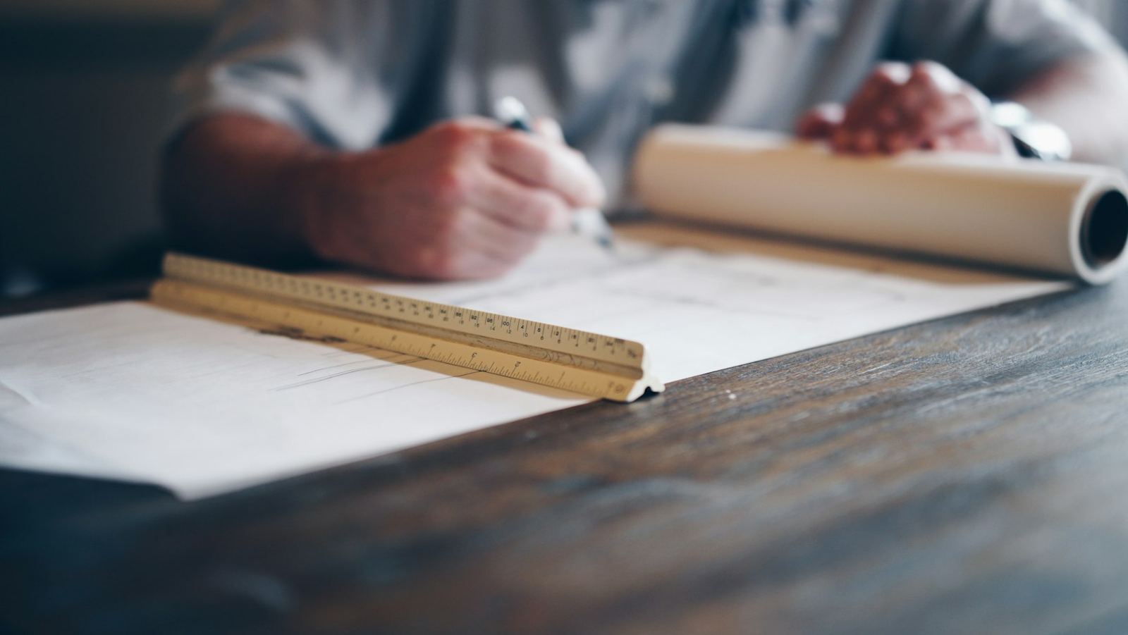 Hand drafting plans with a scale ruler